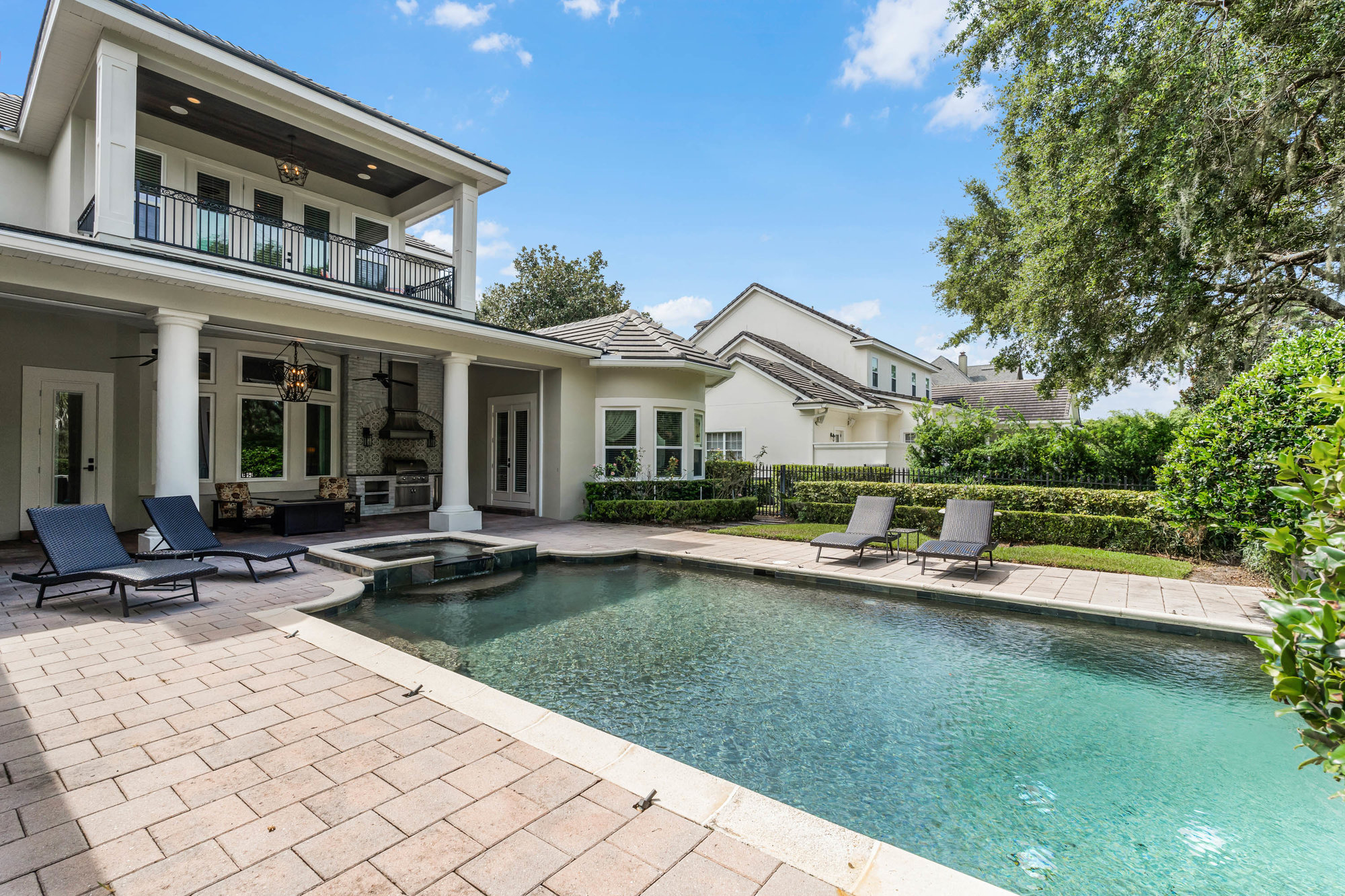 back of home with patio and pool